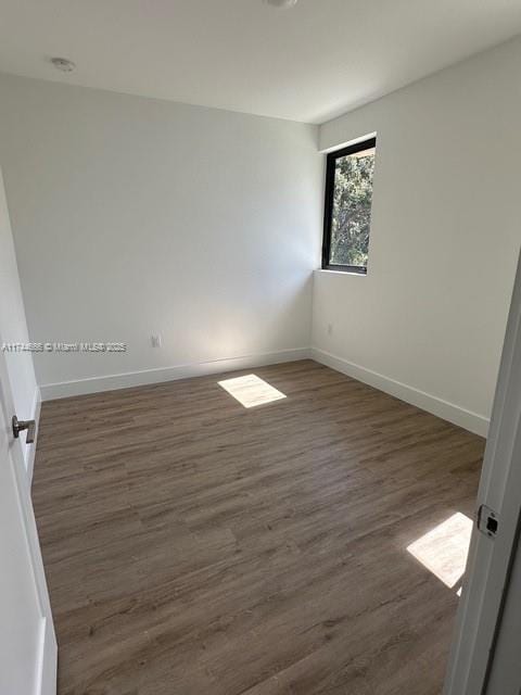 unfurnished room featuring dark hardwood / wood-style floors