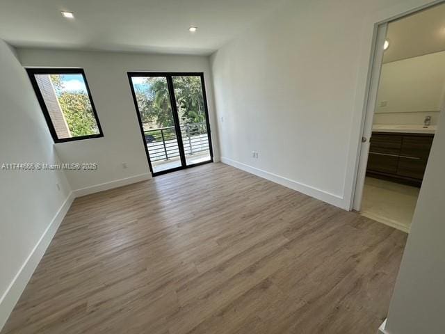 empty room with a healthy amount of sunlight and light wood-type flooring