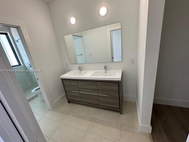 bathroom with vanity, tile patterned floors, and toilet