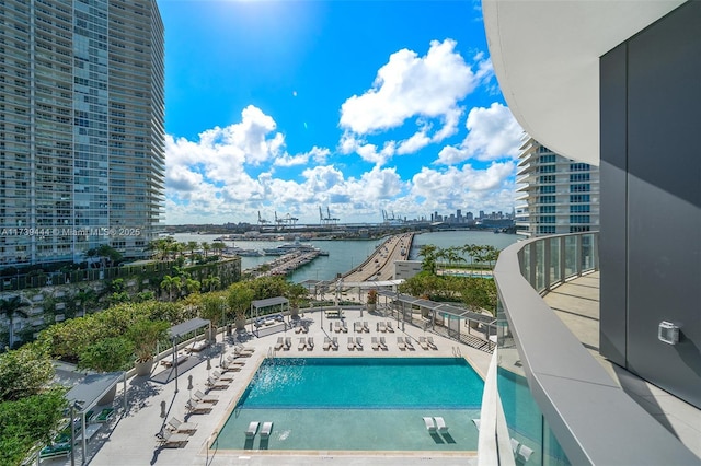 view of pool with a patio and a water view