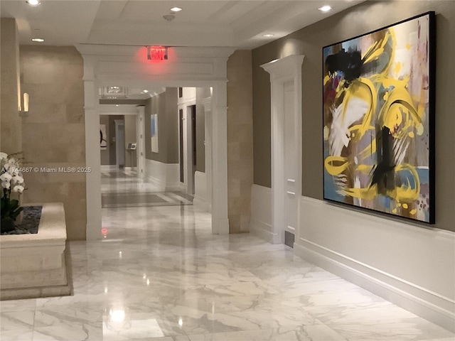 hallway featuring decorative columns