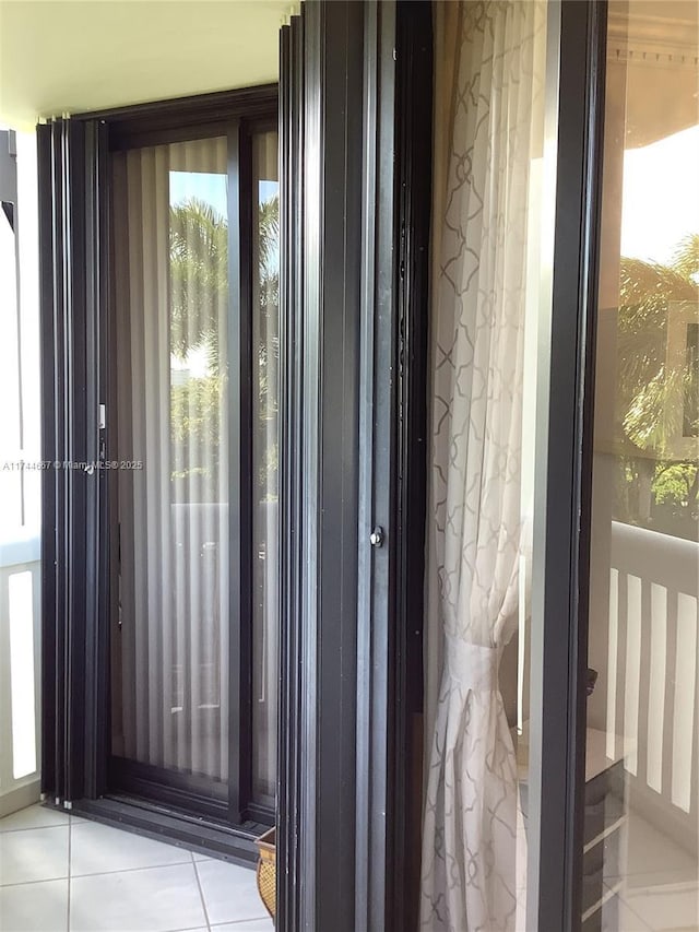 doorway to outside featuring light tile patterned flooring