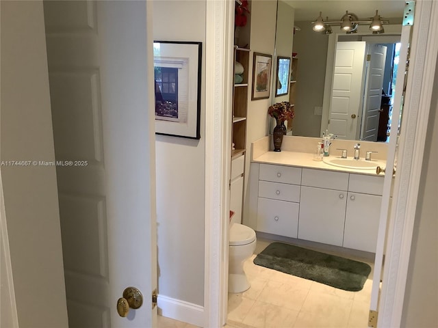 bathroom with tile patterned flooring, vanity, and toilet