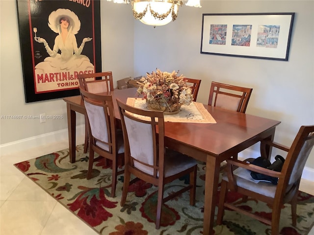 tiled dining space with a chandelier