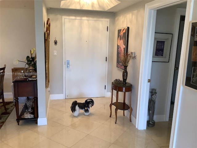 doorway to outside with light tile patterned flooring