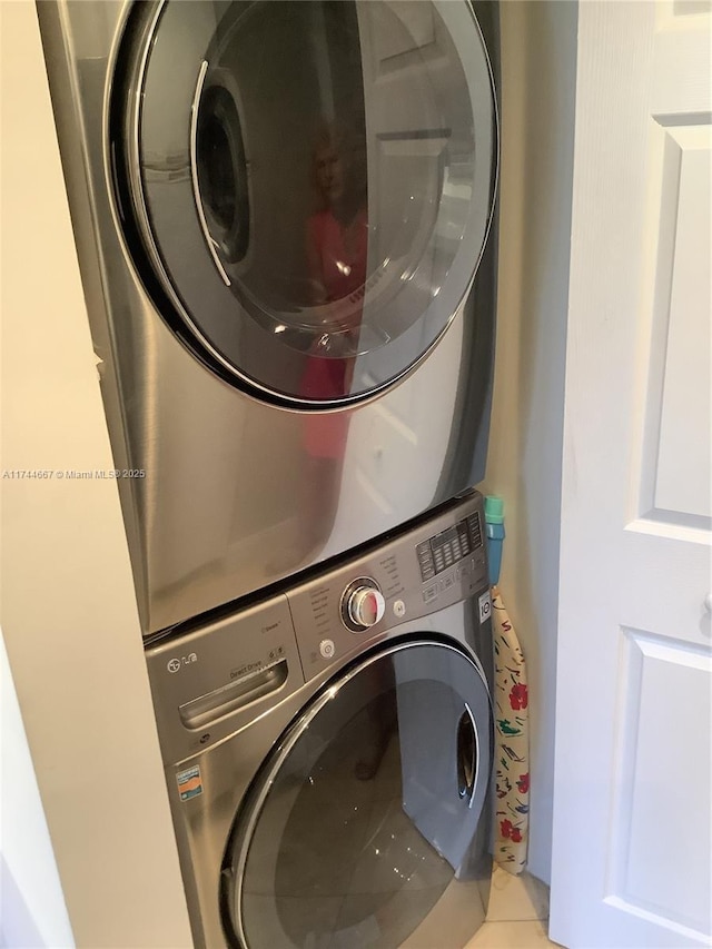 washroom featuring stacked washer / dryer