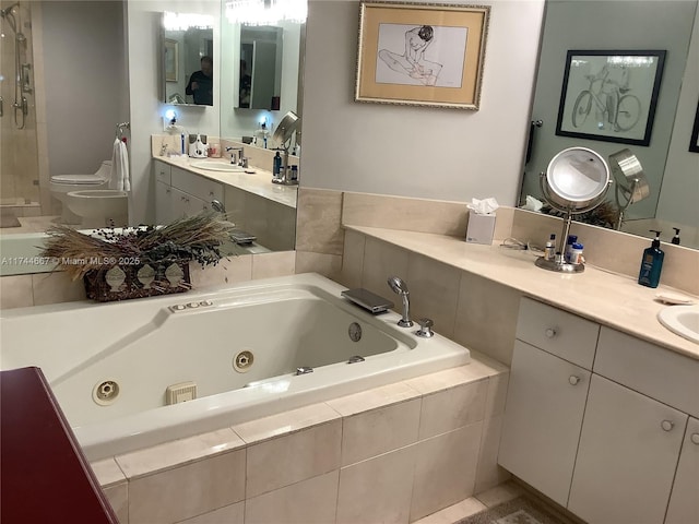 bathroom featuring vanity, tiled bath, and toilet