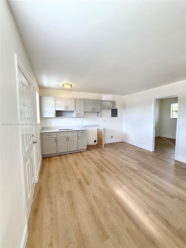 kitchen with gray cabinets and light hardwood / wood-style flooring