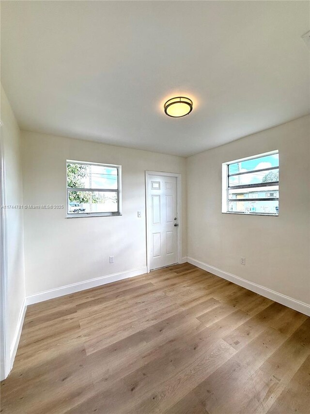 empty room with plenty of natural light and light wood-type flooring