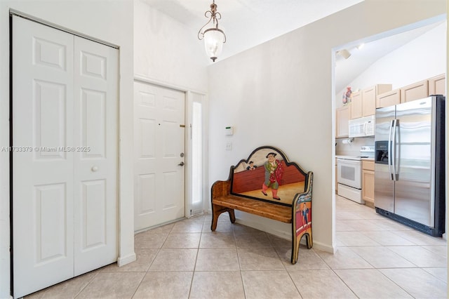 tiled entrance foyer with lofted ceiling