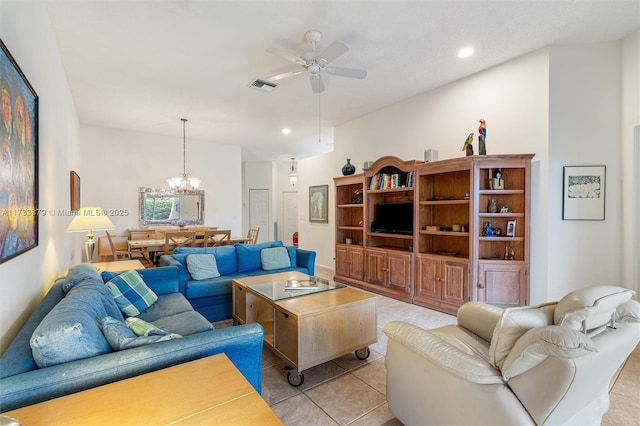 living room with ceiling fan with notable chandelier and light tile patterned floors