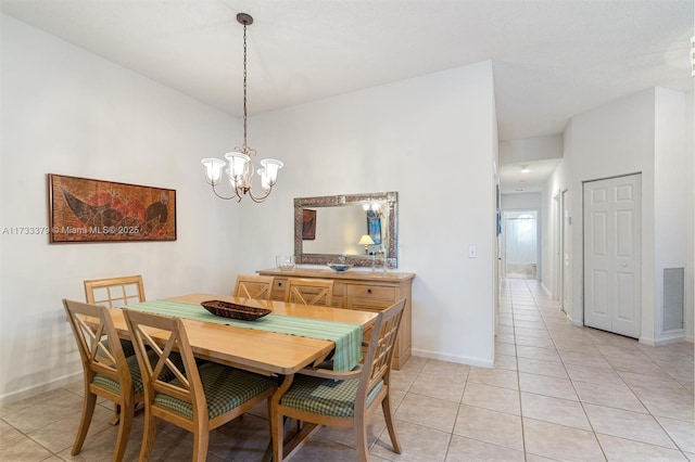 dining space featuring an inviting chandelier and light tile patterned floors