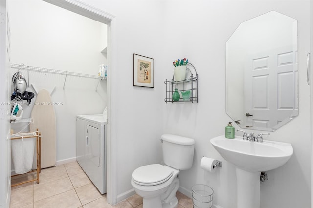 bathroom featuring tile patterned flooring, sink, independent washer and dryer, and toilet