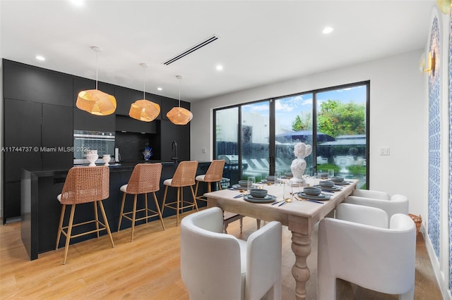 dining space featuring light wood-type flooring