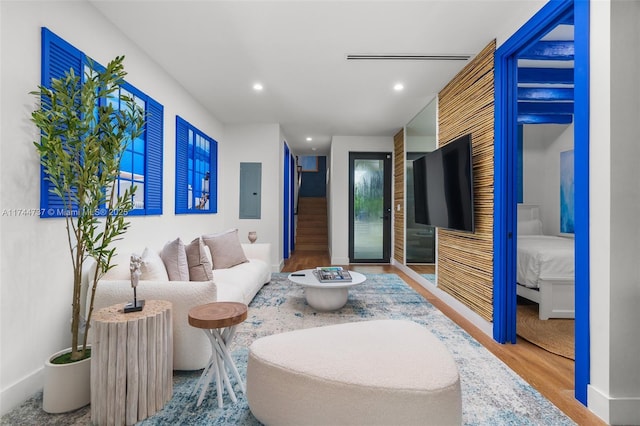 living room featuring hardwood / wood-style floors and electric panel