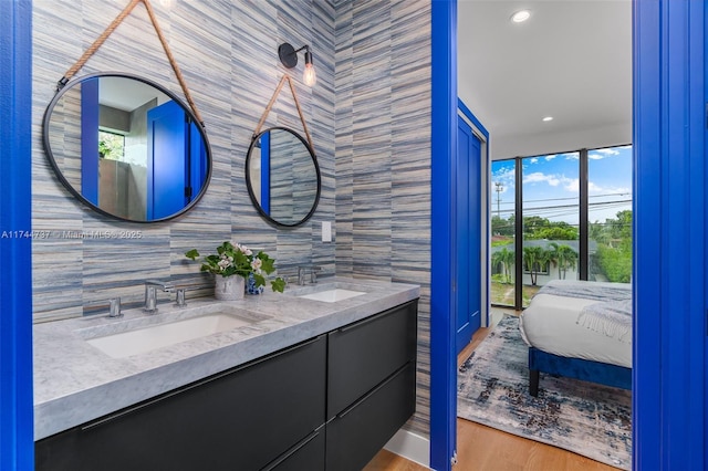 bathroom featuring vanity, decorative backsplash, wood-type flooring, and tile walls