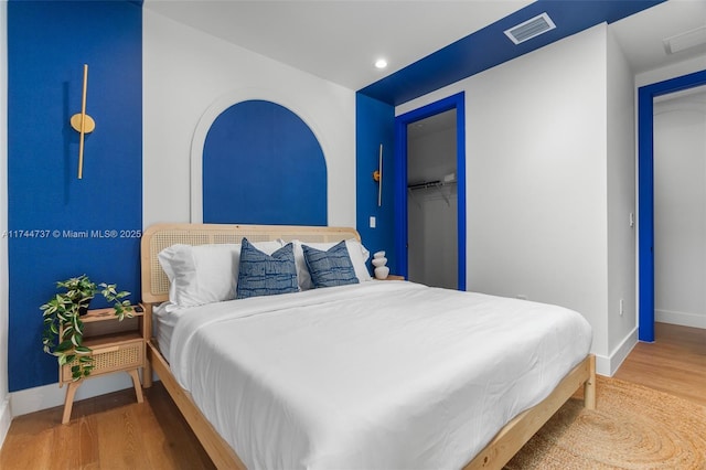 bedroom with hardwood / wood-style flooring and a closet