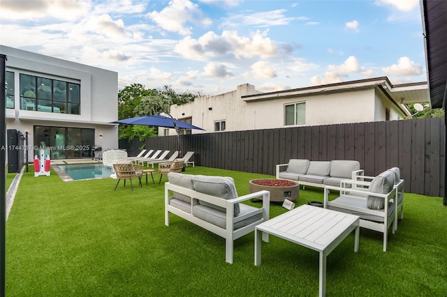 view of yard featuring an outdoor living space and a fenced in pool