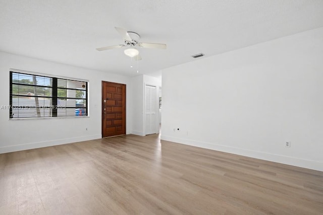 empty room featuring ceiling fan and light wood-type flooring