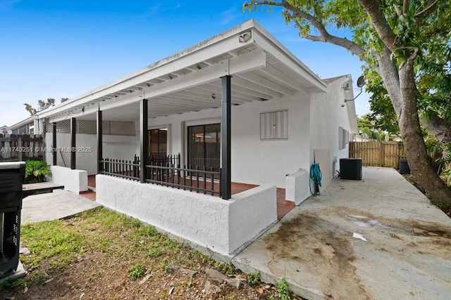 view of side of property featuring a patio and central air condition unit