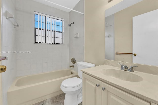 full bathroom with tiled shower / bath, vanity, and toilet