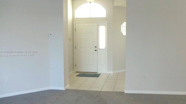 575 SE 29th Dr, Homestead, FL 33033 - foyer with light tile patterned flooring, baseboards, and light carpet