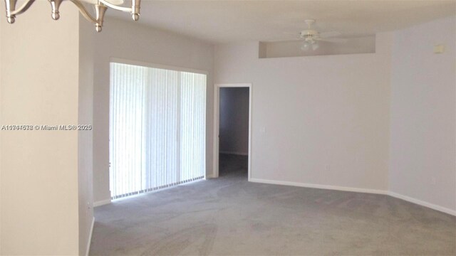 575 SE 29th Dr, Homestead, FL 33033 - carpeted empty room with baseboards and ceiling fan with notable chandelier