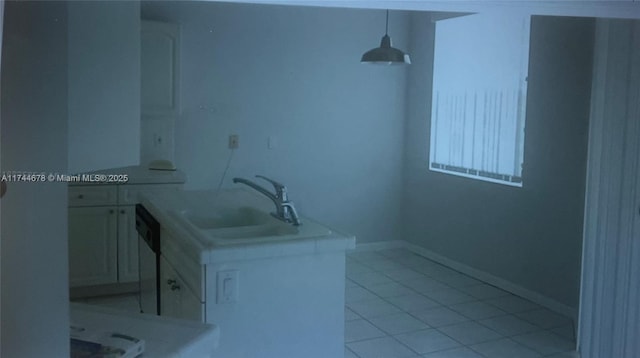 bathroom with baseboards, vanity, and tile patterned floors