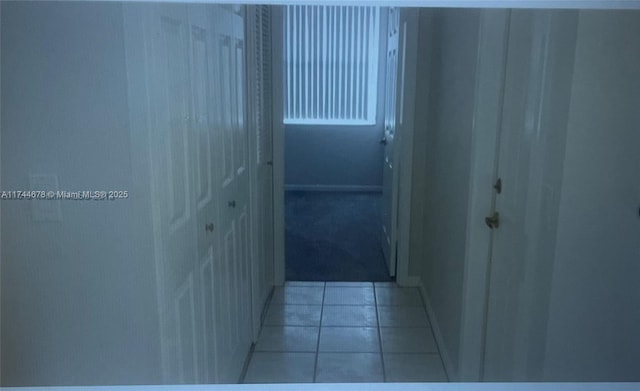 hallway featuring light tile patterned floors