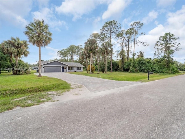 view of front of house featuring a garage and a front lawn