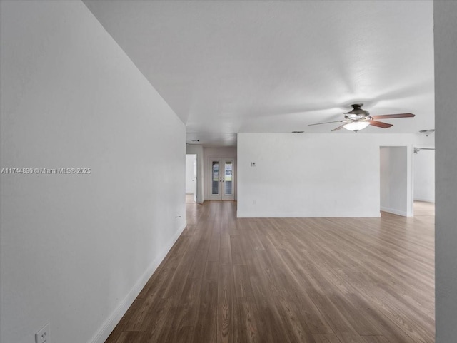 unfurnished room with hardwood / wood-style floors, french doors, and ceiling fan