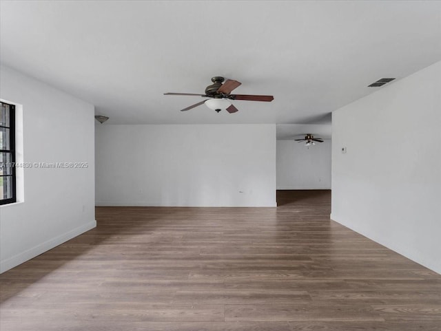 empty room featuring wood-type flooring and ceiling fan