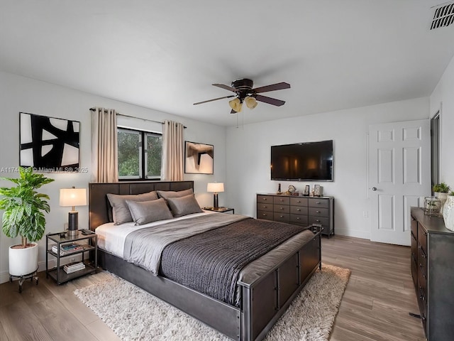 bedroom with hardwood / wood-style floors and ceiling fan