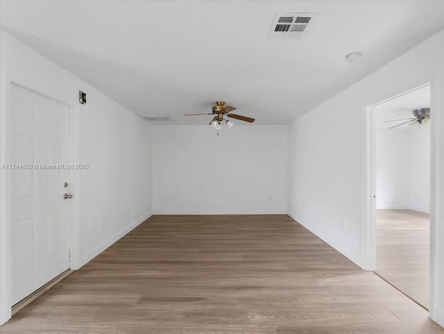 spare room featuring light hardwood / wood-style floors and ceiling fan