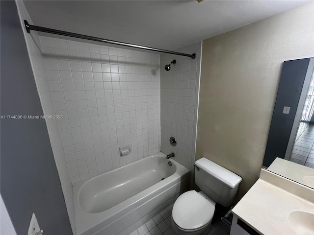 full bathroom featuring vanity, tile patterned floors, toilet, and tiled shower / bath