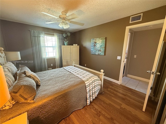 609 Waterside Dr Unit 609, Hypoluxo, FL 33462 - bedroom with wood finished floors, a textured ceiling, and ceiling fan