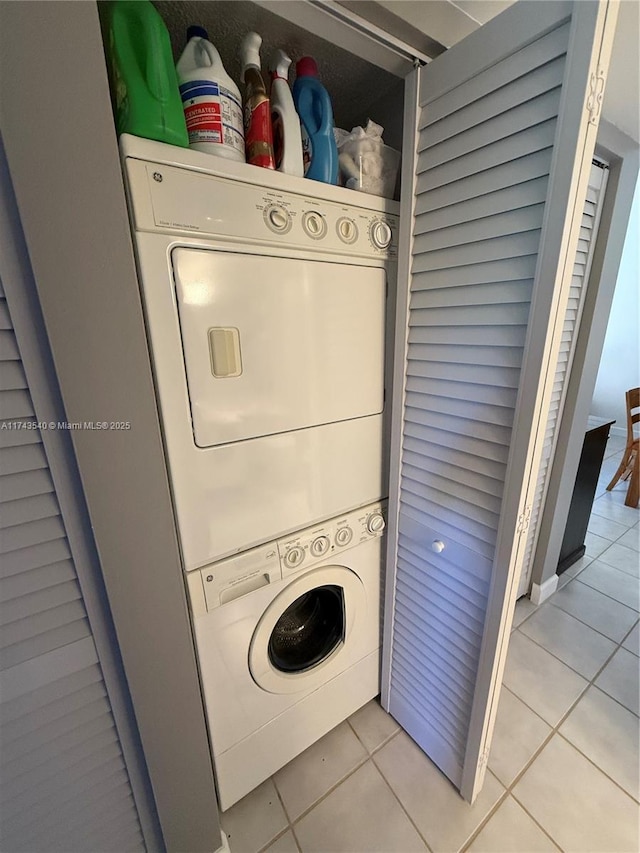 609 Waterside Dr Unit 609, Hypoluxo, FL 33462 - laundry room featuring stacked washer and clothes dryer and light tile patterned flooring