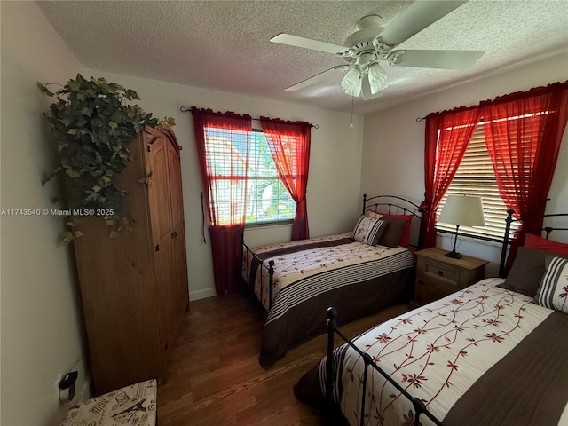 609 Waterside Dr Unit 609, Hypoluxo, FL 33462 - bedroom featuring wood finished floors, multiple windows, a textured ceiling, and ceiling fan