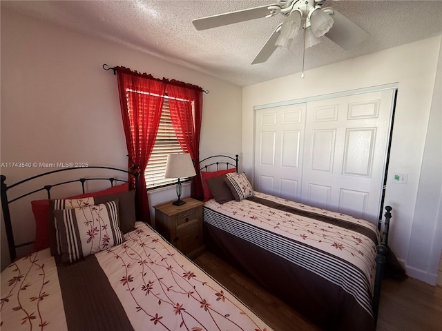 609 Waterside Dr Unit 609, Hypoluxo, FL 33462 - bedroom featuring a textured ceiling, wood finished floors, a closet, and a ceiling fan