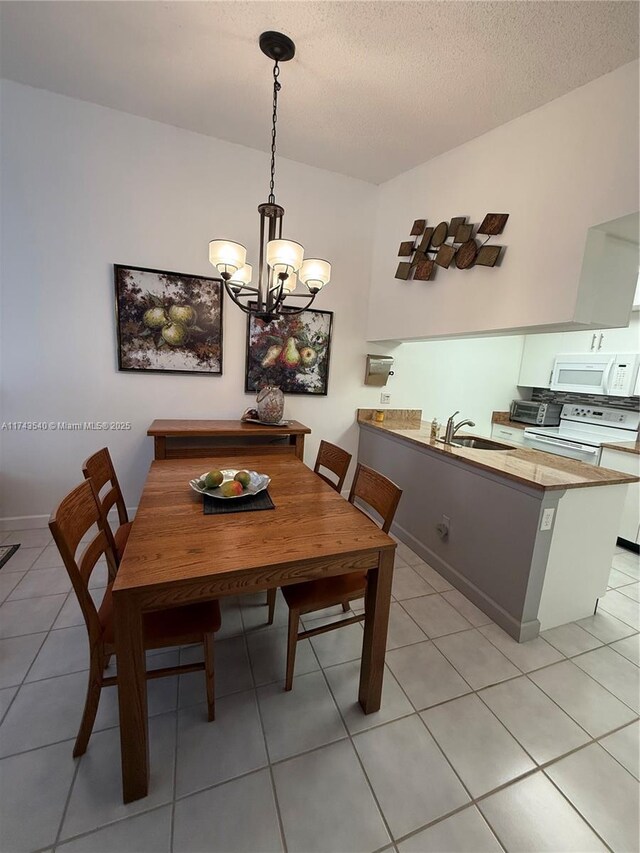 609 Waterside Dr Unit 609, Hypoluxo, FL 33462 - dining area with a chandelier, light tile patterned flooring, and a textured ceiling
