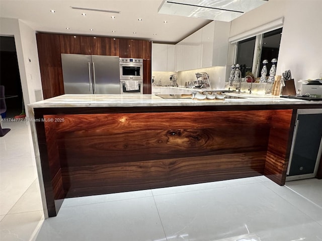 kitchen featuring stainless steel appliances and white cabinets