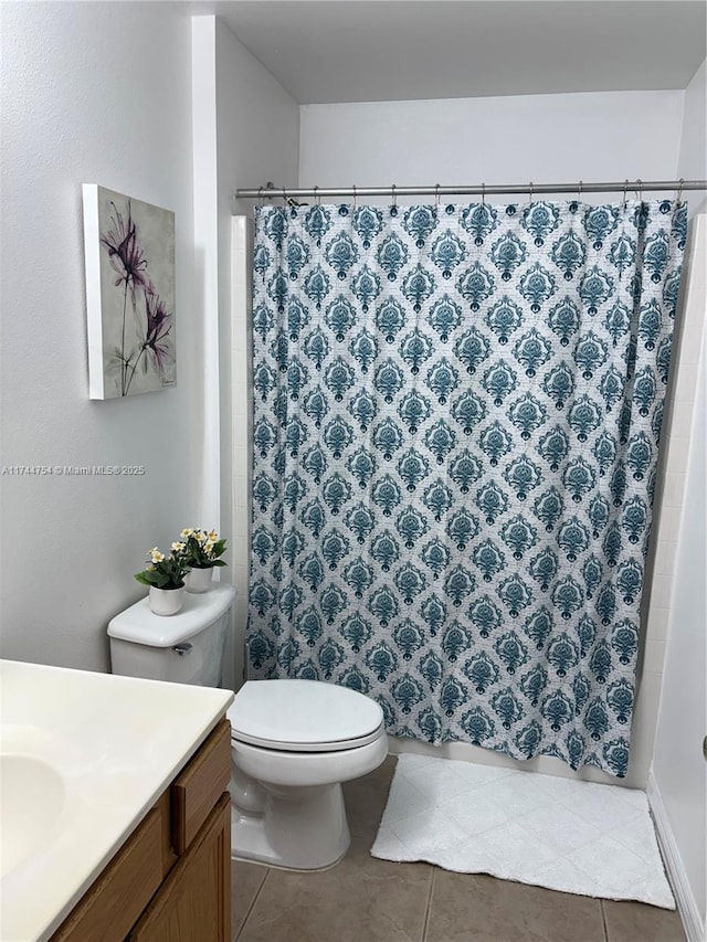 bathroom featuring vanity, tile patterned floors, and toilet