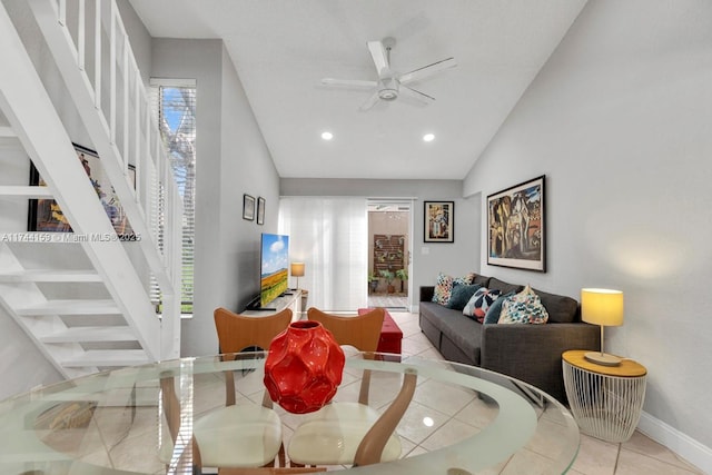 tiled living room featuring lofted ceiling and ceiling fan