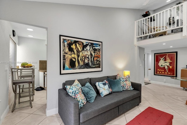 living room featuring a towering ceiling and light tile patterned flooring