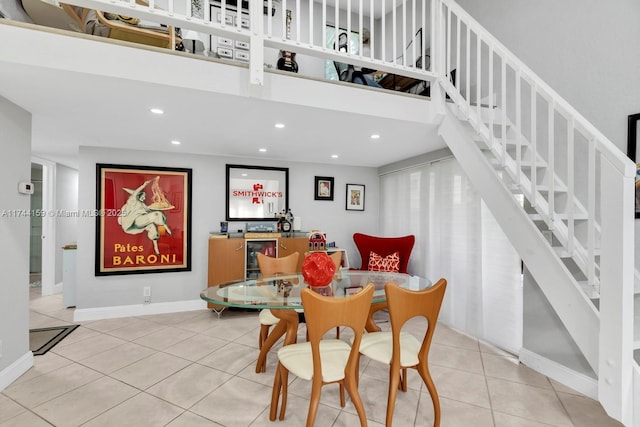 tiled dining space featuring a high ceiling