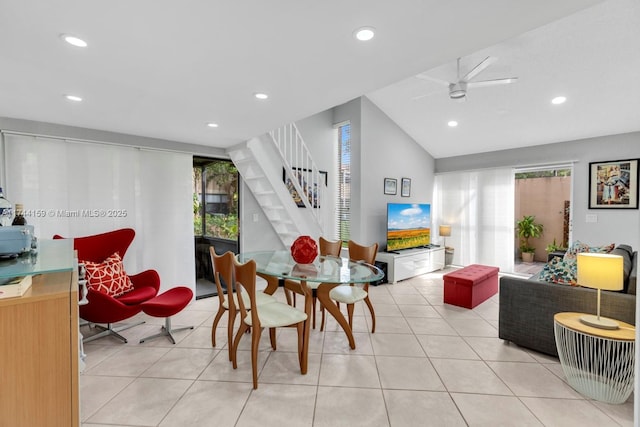 dining room with lofted ceiling, light tile patterned floors, and ceiling fan