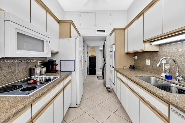 kitchen with sink, white appliances, and white cabinets