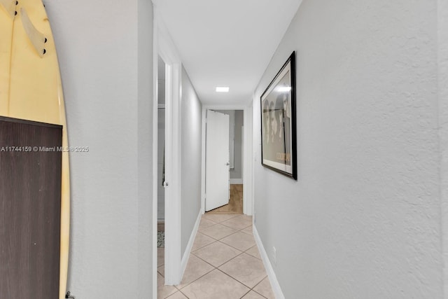 hall featuring light tile patterned floors