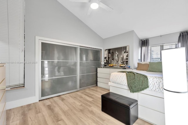 bedroom featuring lofted ceiling, light hardwood / wood-style floors, and ceiling fan