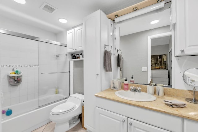 full bathroom with vanity, tile patterned floors, enclosed tub / shower combo, and toilet